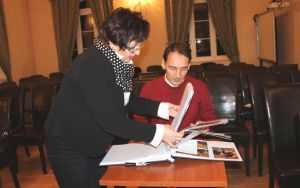 Sabina Jankowska and Alexey Komarov looking at the concert chronicle in the District Office in Trzebnica. Photo by Jowita Małogoska.